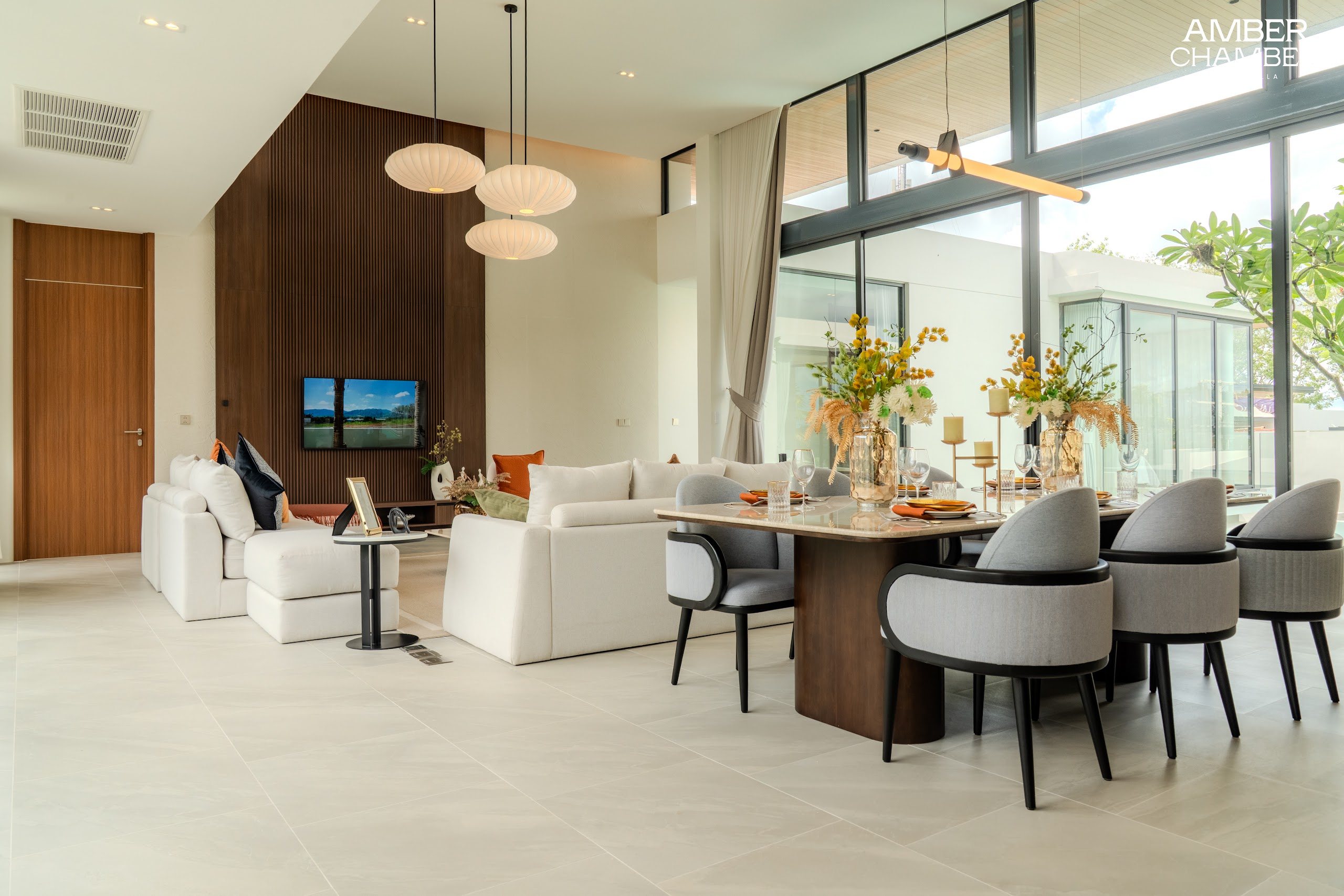 Open-plan living and dining area inside an Amber Chamber pool villa