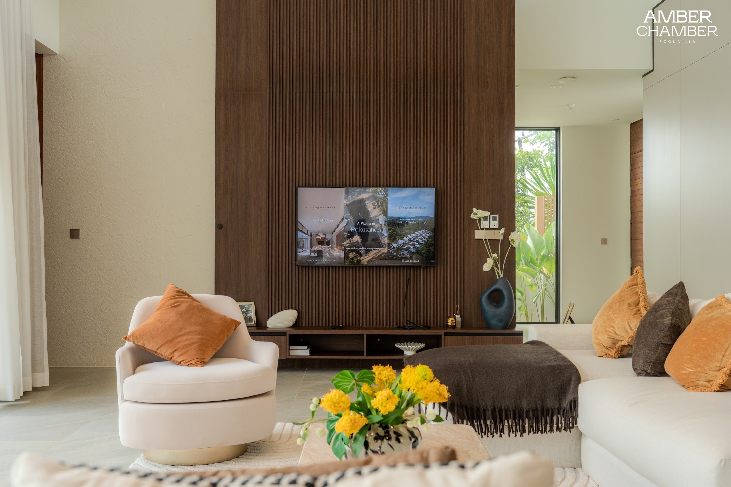 Open-plan living and dining area inside an Amber Chamber pool villa