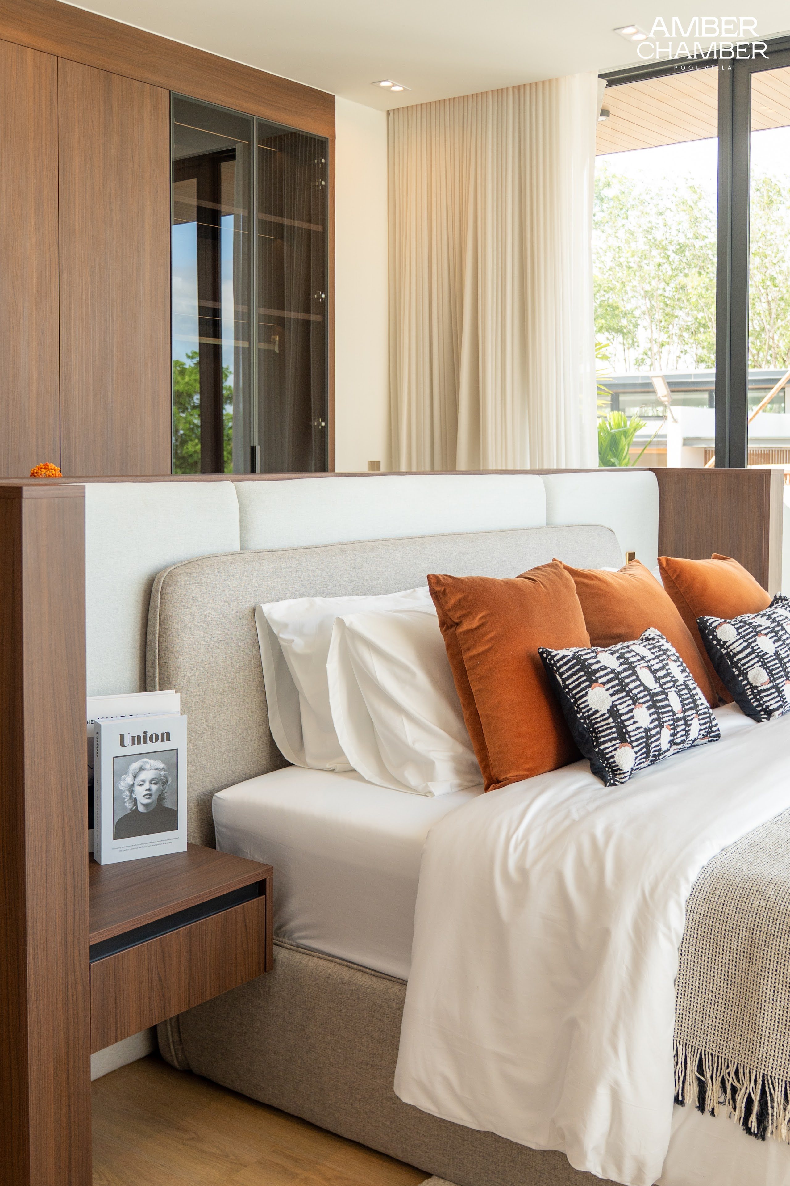 Amber Chamber villa bedroom with timber joinery and layered bed linen