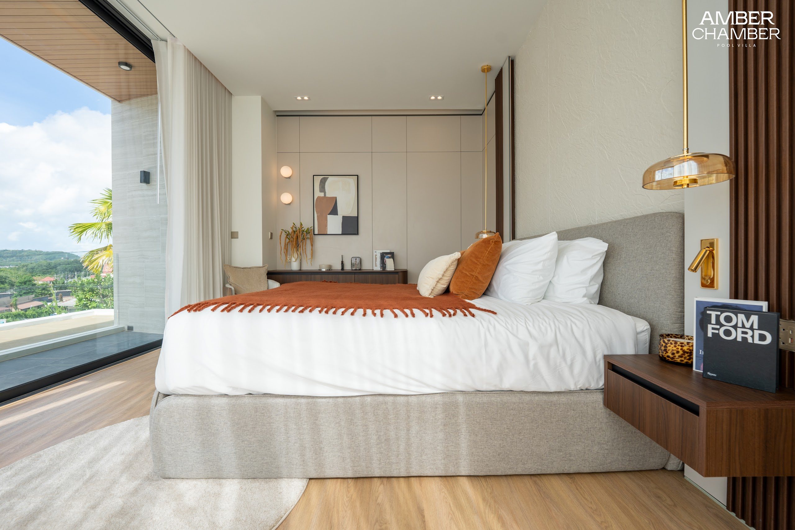 Amber Chamber villa bedroom with timber joinery and layered bed linen
