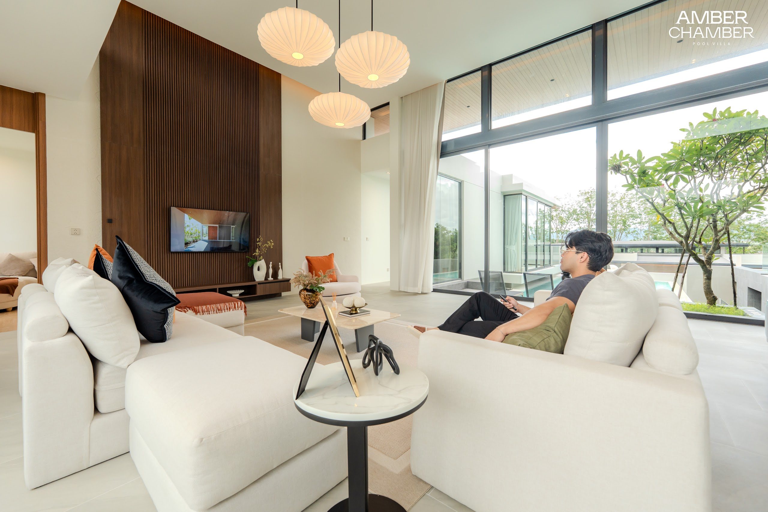 Open-plan living and dining area inside an Amber Chamber pool villa