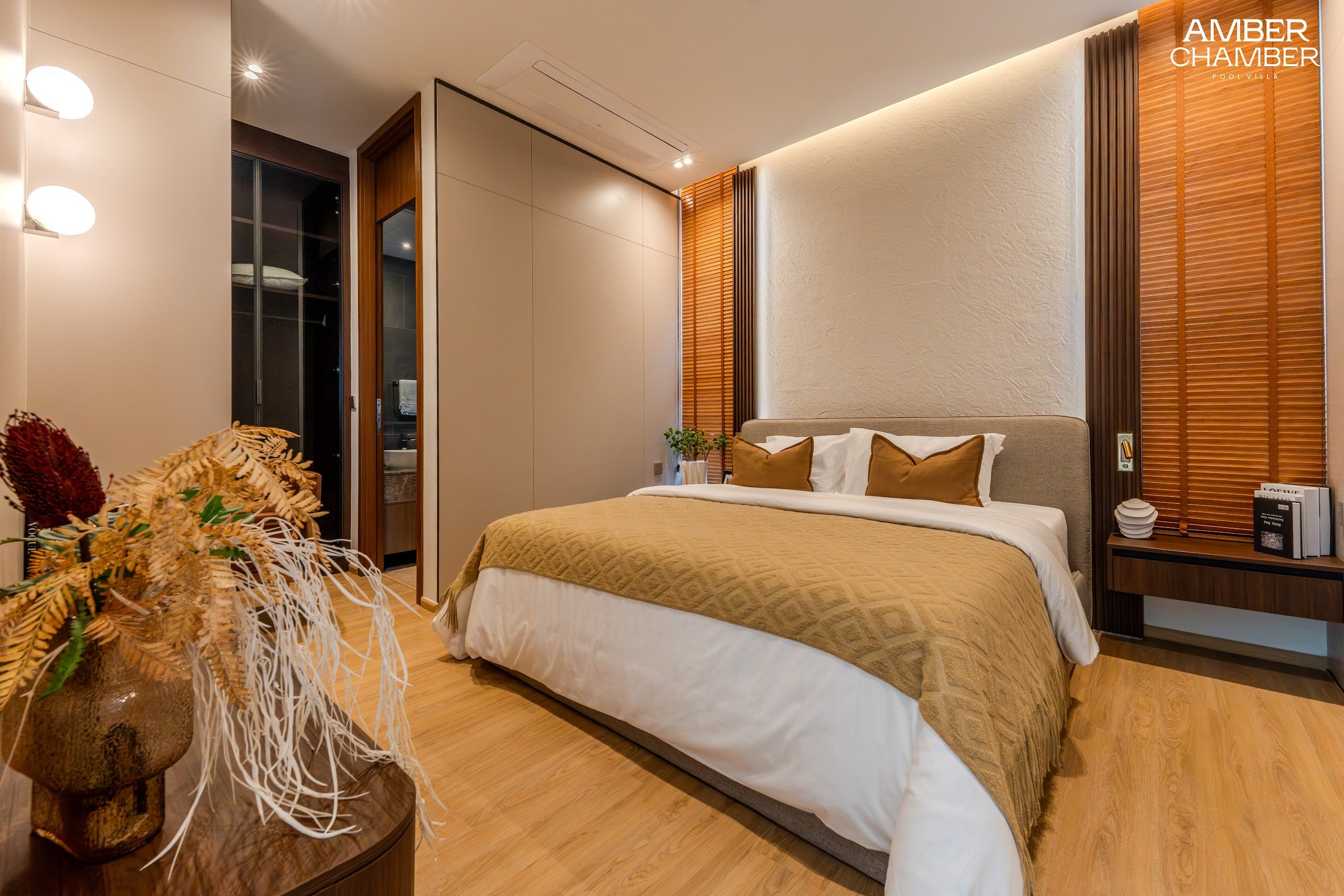 Amber Chamber villa bedroom with timber joinery and layered bed linen