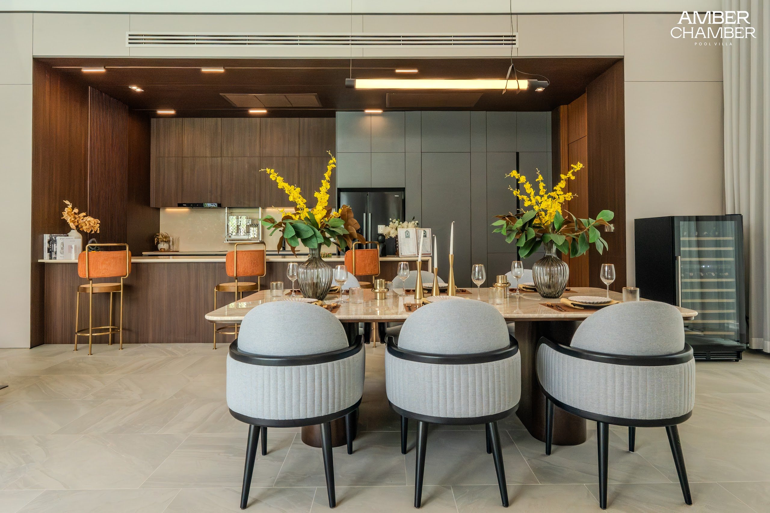 Open-plan living and dining area inside an Amber Chamber pool villa