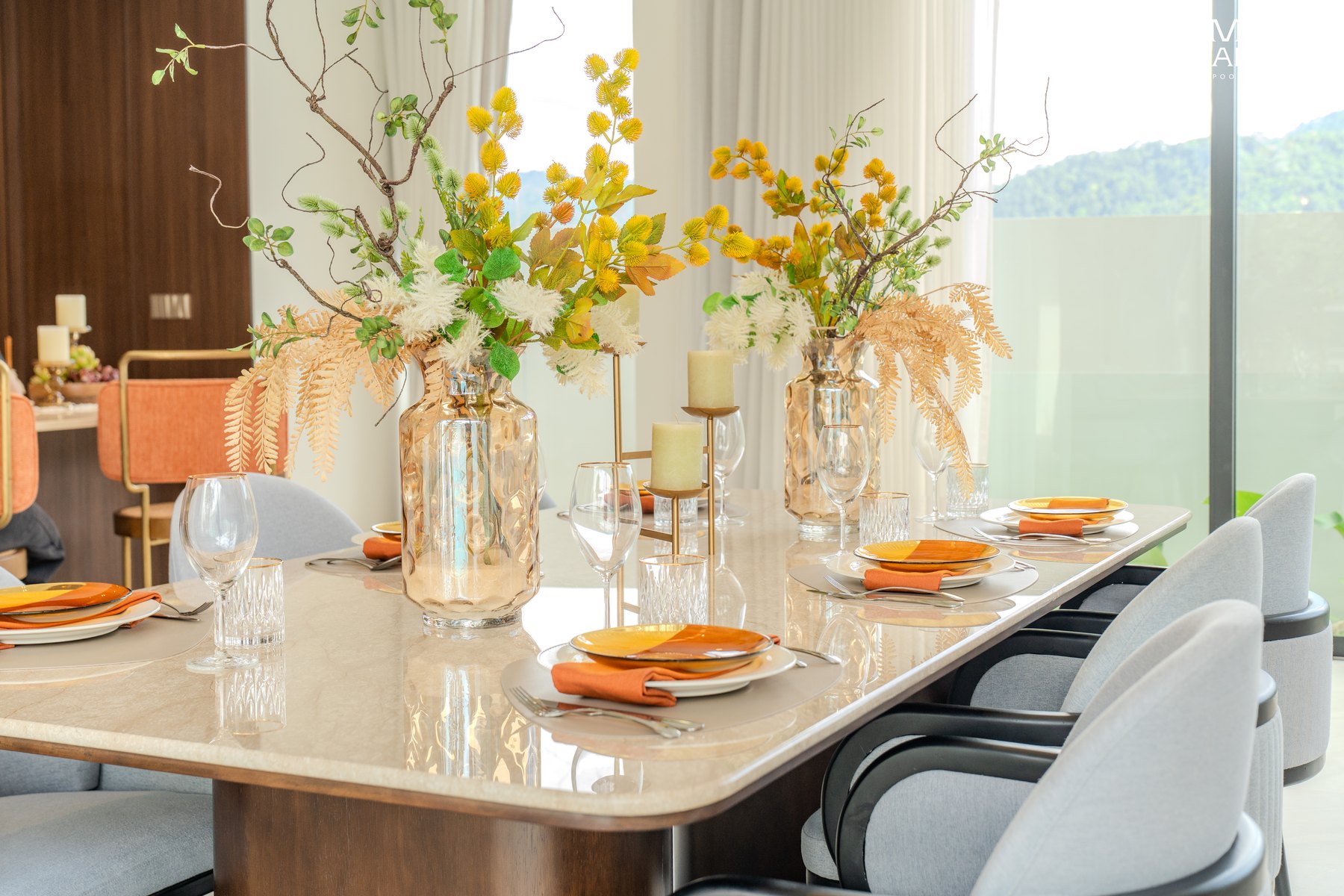 Dining table dressed with stoneware and fresh florals inside an Amber Chamber villa