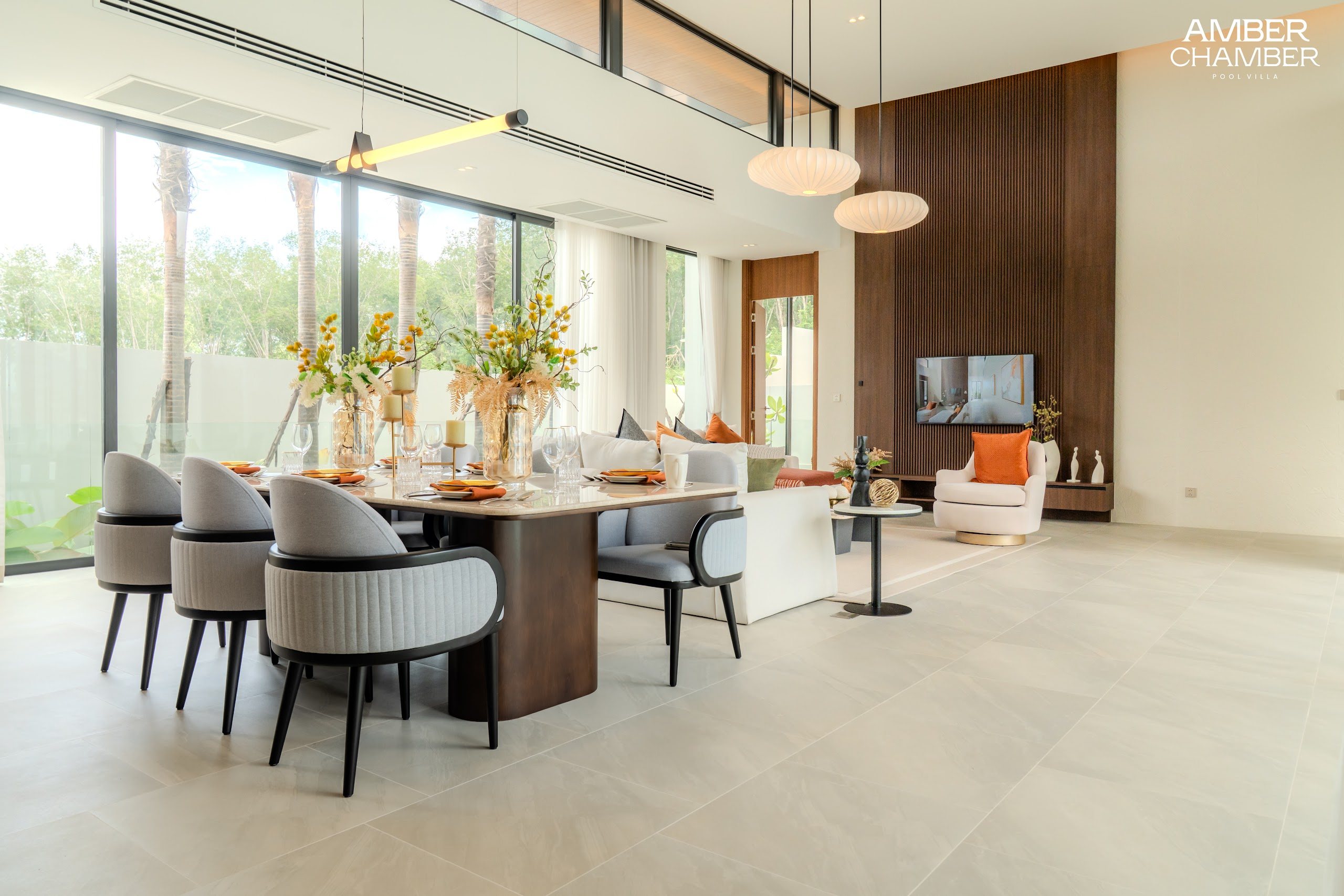 Open-plan living and dining area inside an Amber Chamber pool villa
