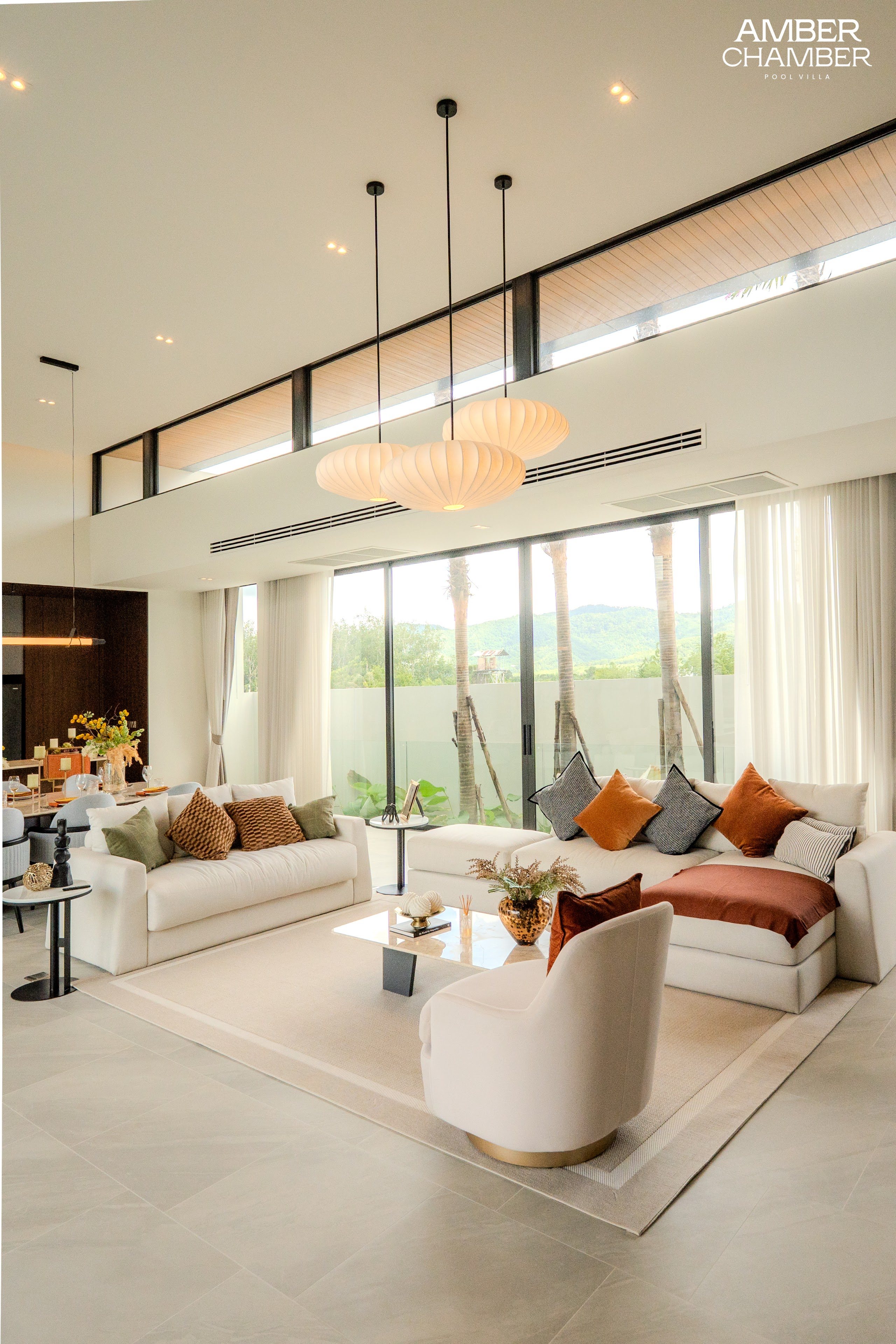 Open-plan living and dining area inside an Amber Chamber pool villa
