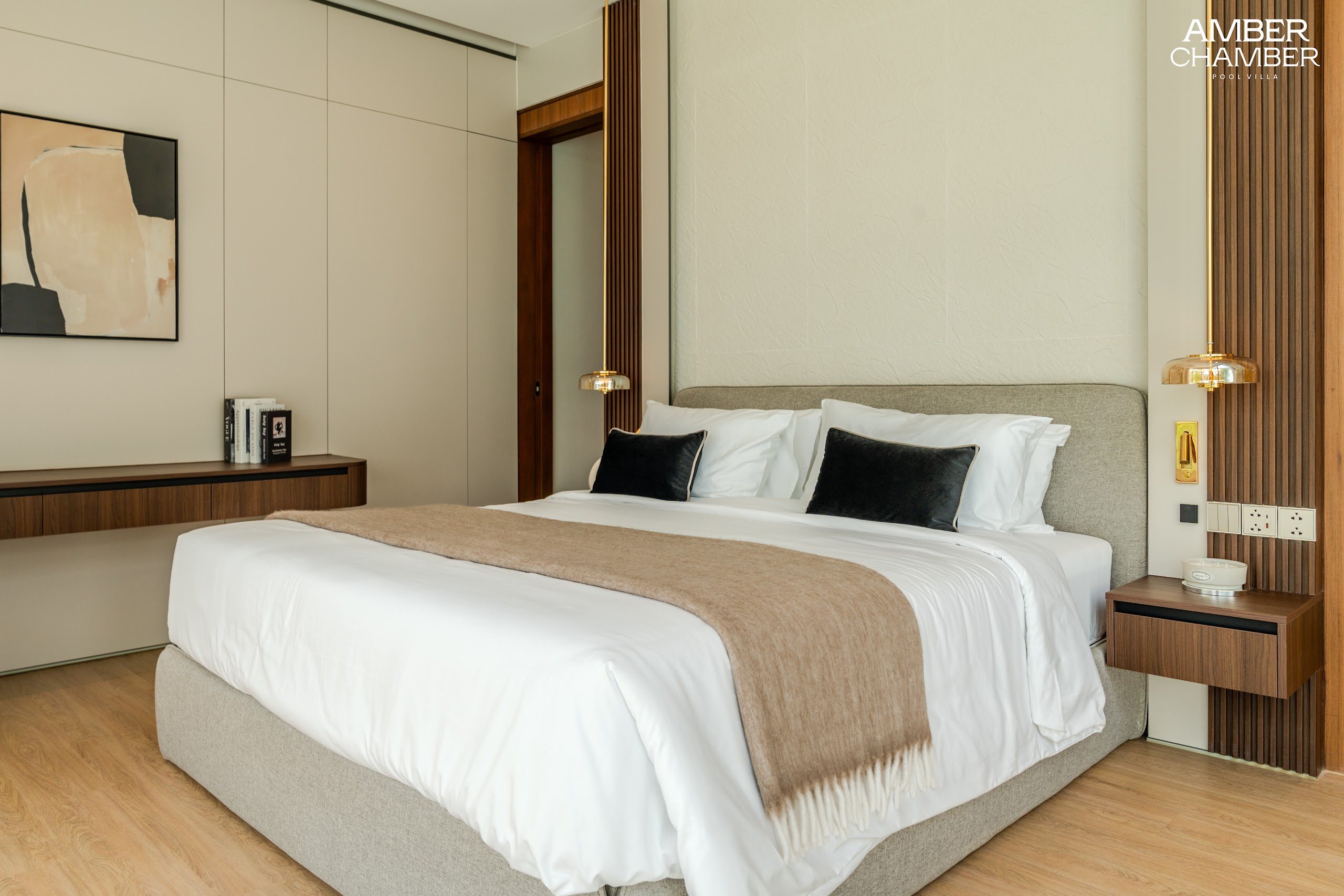 Amber Chamber villa bedroom with timber joinery and layered bed linen