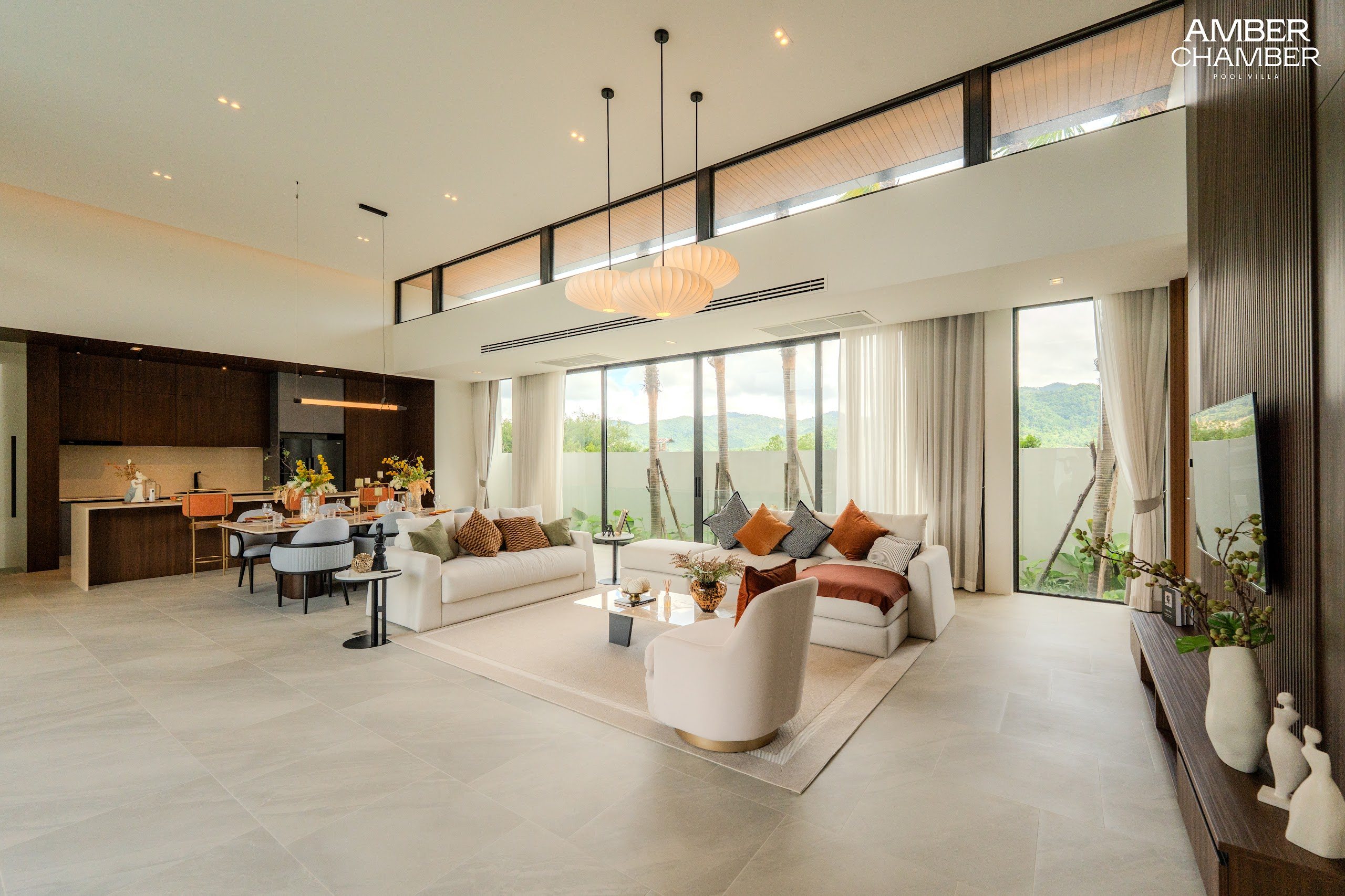 Open-plan living and dining area inside an Amber Chamber pool villa