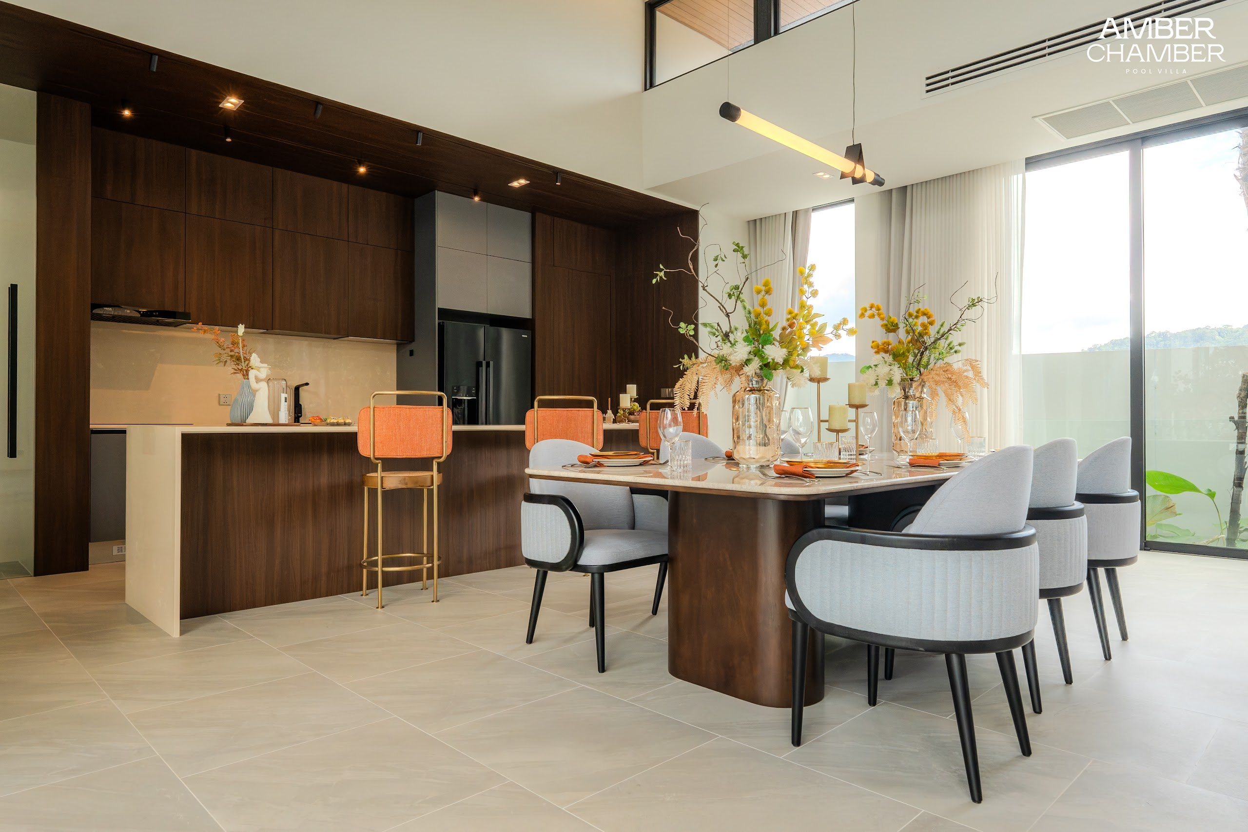 Open-plan living and dining area inside an Amber Chamber pool villa