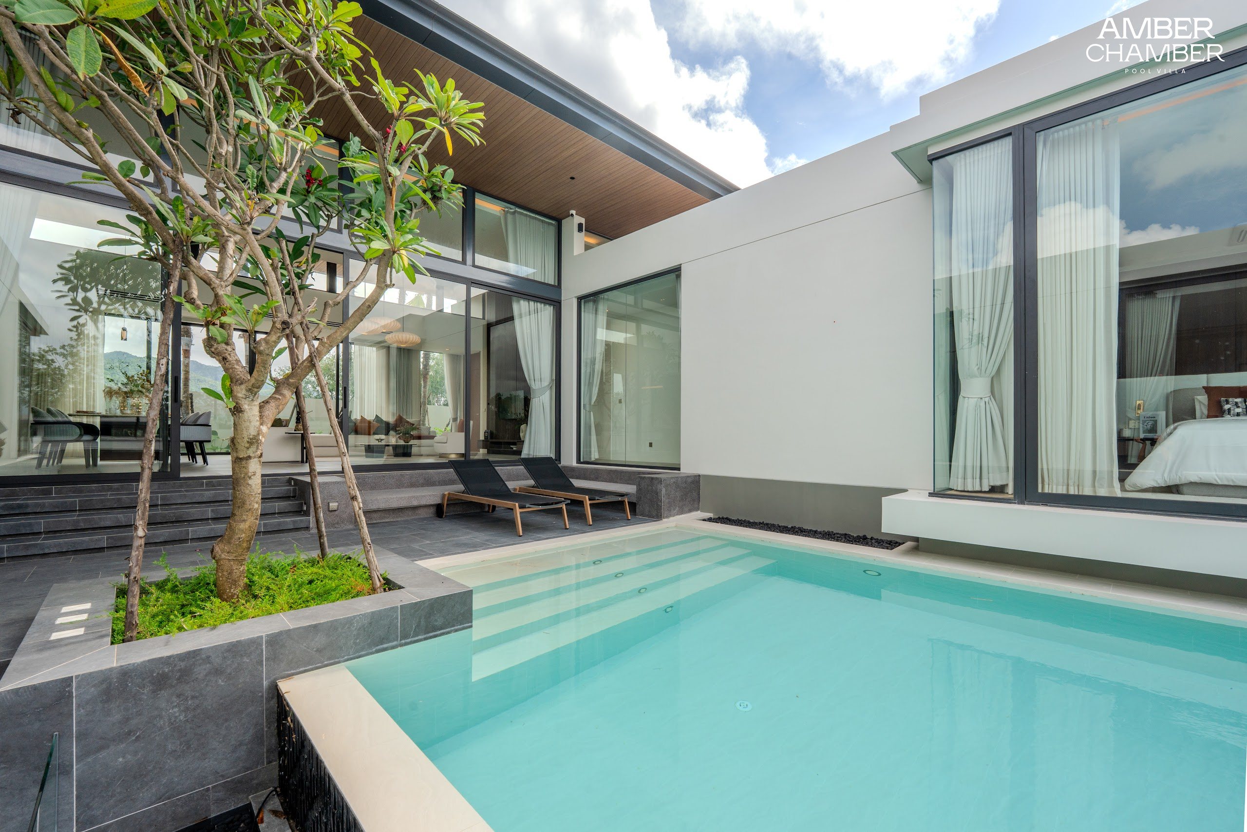 Outdoor living terrace beside the private pool of an Amber Chamber villa