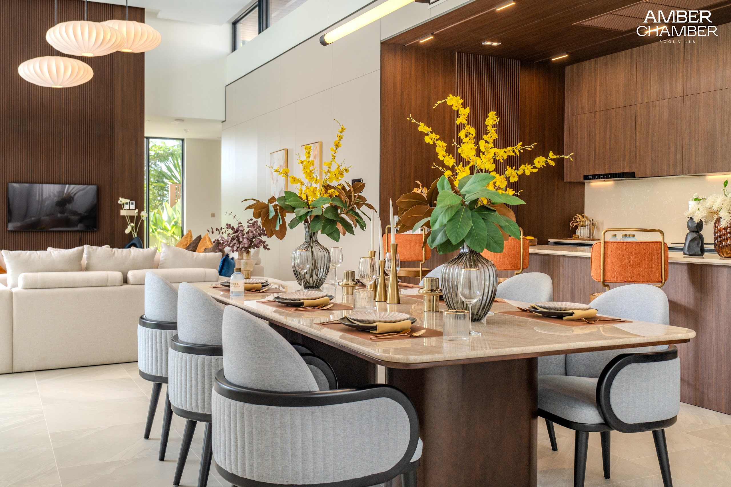 Open-plan living and dining area inside an Amber Chamber pool villa