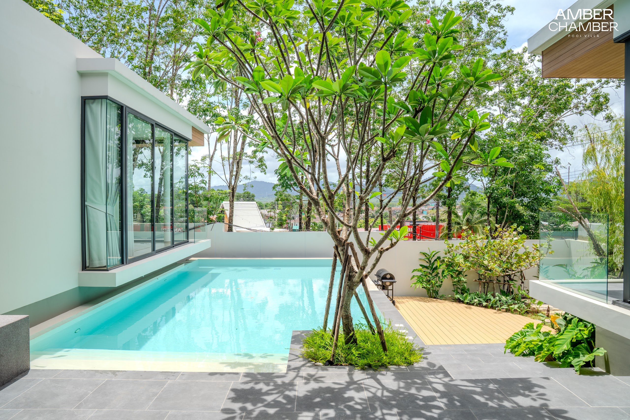 Outdoor living terrace beside the private pool of an Amber Chamber villa