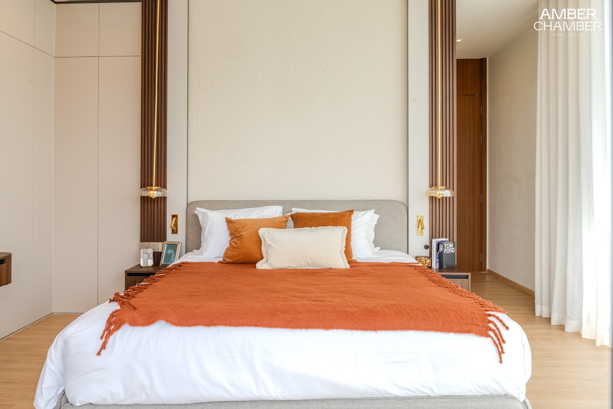 Amber Chamber villa bedroom with timber joinery and layered bed linen