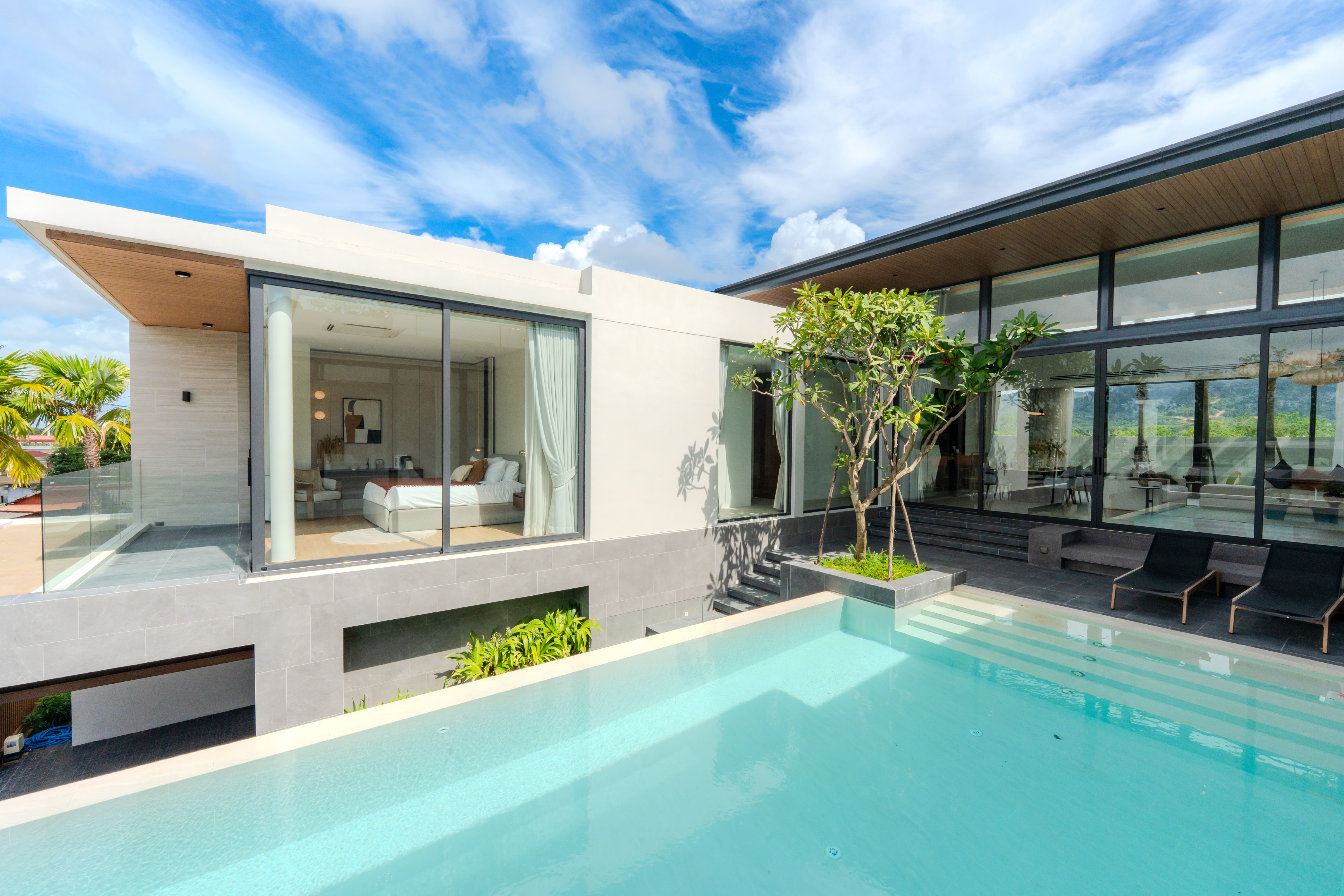Pool villa exterior in daylight with turquoise swimming pool